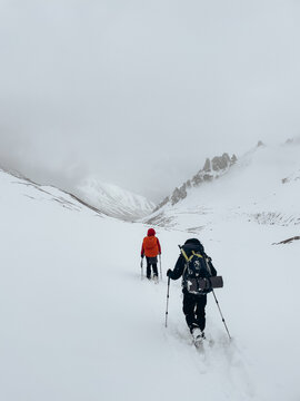 Anonymous travelers walking in highlands in winter