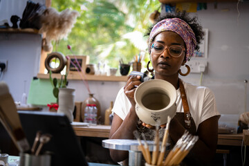 Small business owner working at her pottery desk