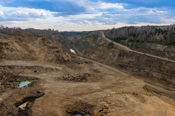 The production of graphite. Deep quarry for the extraction of minerals.