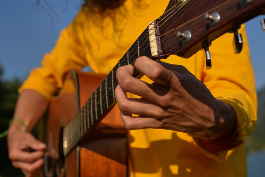 A woman's hands playing guitar 
