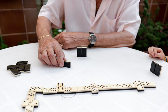 Old man playing dominoes in a residence