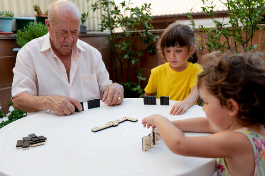 Family time playing domino with great grandfather