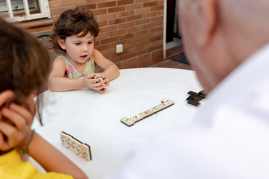 Family time playing domino with great grandfather