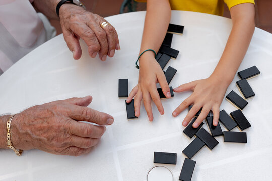 Family time playing domino with great grandfather