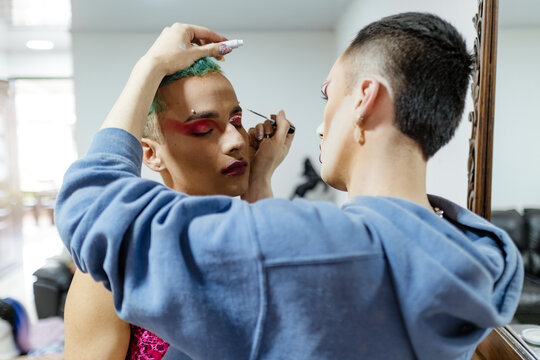 Latino friends applying makeup