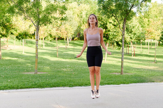 Woman skipping outside in a park