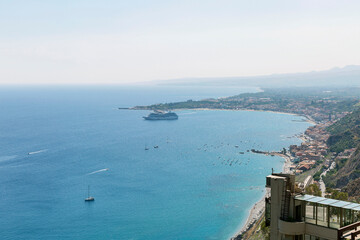 Beautiful coast on a sunny day. Floating yachts on a calm sea and ancient buildings on the shore.