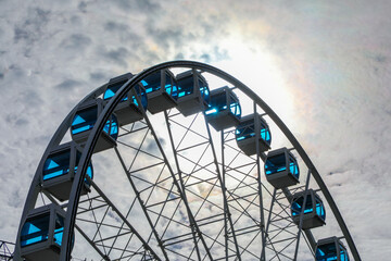 Helsinki ferris wheel silhouetted against a cloudy sky