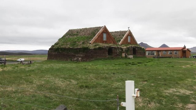 Turf houses in Iceland with gimbal video walking forward.