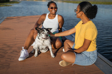 friends with dog on a pier