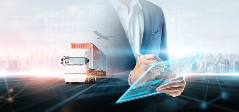 Business and technology digital future of cargo containers logistics transport import export concept, Double exposure business man using tablet control freight truck, Modern futuristic city background