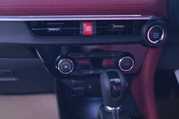 Fototapeta premium Finger pressing the emergency light button in the car indicates danger. Alarm button in the car. red triangle