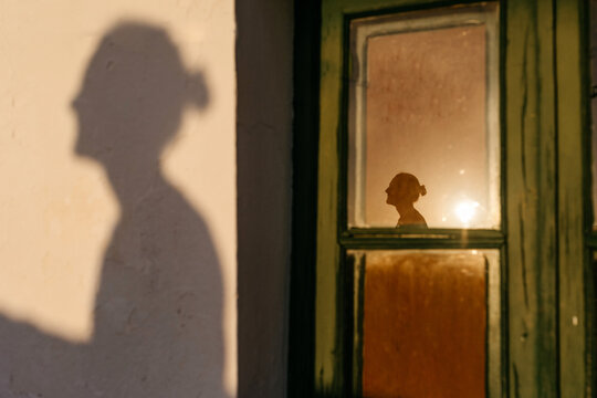 Silhouette of man on wall and window
