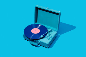 violet and pink disc in a blue turntable
