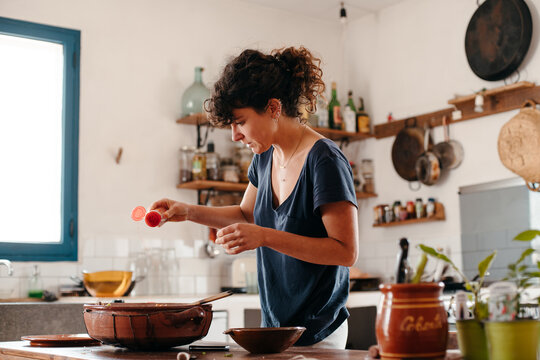 Woman Cooking A Traditional Dish In The Kitchen