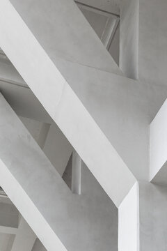 Close-up of interior ceiling and columns of concrete building.