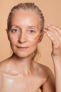 Woman Taking Serum With A Dropper