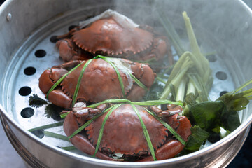 Selective focus Fresh crab Cooked steamer food on steaming pot seafood and  vegetable with steam...