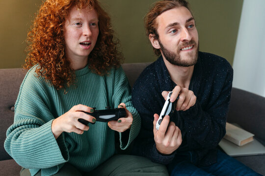 Friends play videogame together.