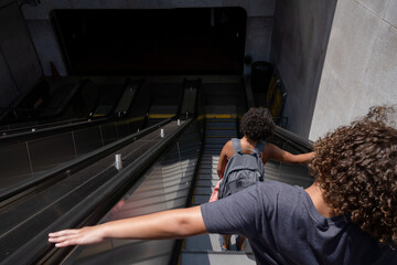 Siblings descend escalator