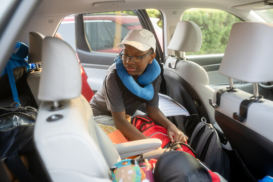 Boy with travel pillow in SUV