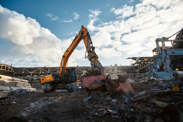 Excavator destroyer removes debris winter day
