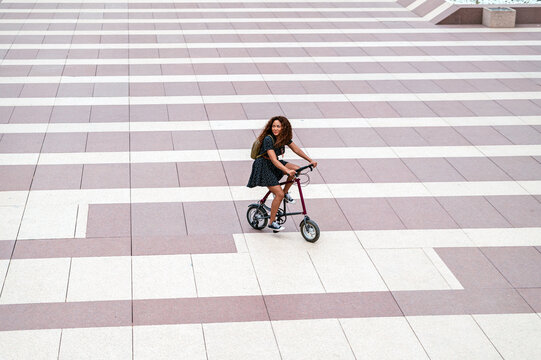 Black female riding bike on pavement