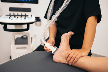 Professional physiotherapist doing an ultrasound scan to a patient