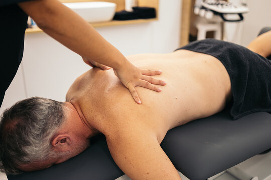 Therapist massaging a patient in a physiotherapy clinic