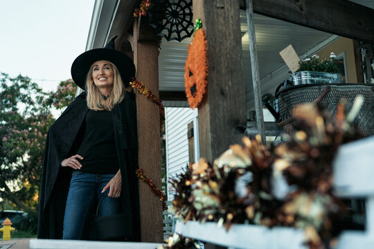 Shopkeeper Witch Waiting For Trick Or Treaters On Halloween