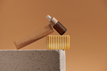 Eco friendly concept with skincare oil bottle, comb and organic soap