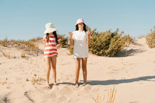 Girls with hats summer vibes at the beach