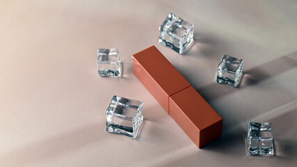 Studio pink lipstick packaging with ice cubes.