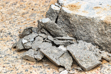 Broken concrete curb. Crushed concrete. Poor quality concrete.