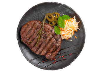 Cooked ribeye steak in a plate. View from above. Transparent.