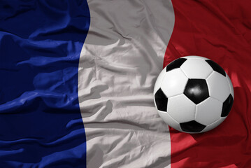 vintage football ball on the waveing national flag of france background. 3D illustration