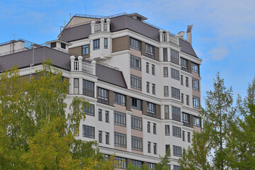 Fragment of the facade of a multi-storey residential building on an autumn day