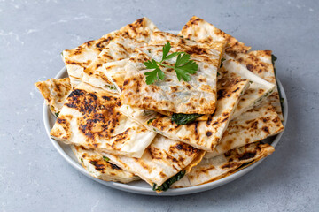 Traditional Turkish food, Turkish pancake gozleme with cheese and herb. The appetizer is Turkish pastry. There are varieties such as cheese, spinach, potato