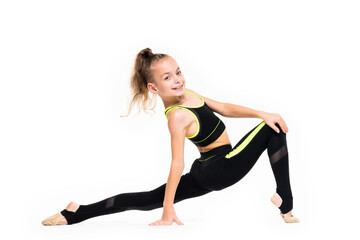 Fototapeta na wymiar Flexible little girl gymnast in black sports gymnastic suit does acrobatic exercises isolated on a white background with space for text or logo. Sport, workout, fitness, yoga, active lifestyle concept