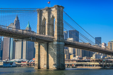 Brooklyn bridge and Manhattan skyline from hudson river, New York, United States