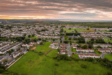 Aerial view on a city residential area with houses and park. Galway, Ireland. Blue cloudy sky. High density urban land.