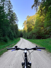 Fototapeta na wymiar Bike handlebar first person view. Concept of outdoor riding mountain bike.