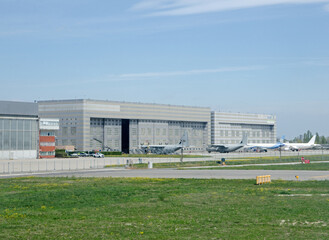 Fototapeta na wymiar Military aircraft and SuperJet International hangars, Venice Airport, Italy