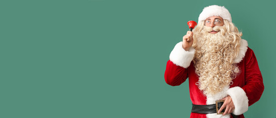 Santa Claus with Christmas bell on green background with space for text