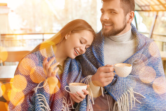 Young couple drinking coffee in outdoor cafe