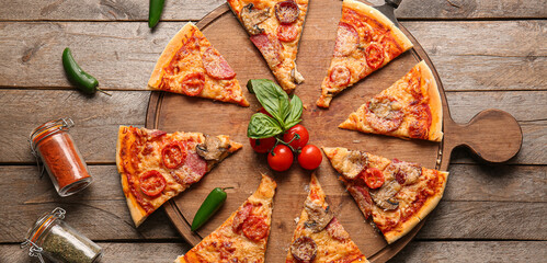 Composition with tasty sliced pizza on wooden background, top view