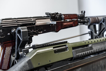 Automatic rifle on stand on the table of the weapons workshop.