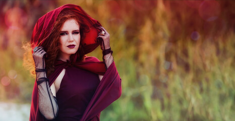 Portrait of beautiful young witch outdoors