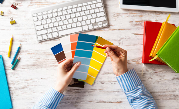 Interior designer choosing colors from swatches
