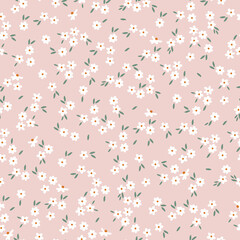 Simple vintage pattern. small white flowers. green leaves. light pink background. Fashionable print for textiles and wallpaper.